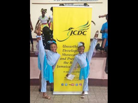 Sisters, Imani Hannigan (left) and Kara Hannigan, JCDC gold medallists in dance, striking a winning pose.