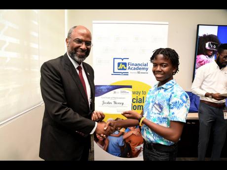 Earl Jarrett (left), chief executive officer and deputy chairman of The Jamaica National Group, presents Justin Stoney, a student at Jamaica College, with a certificate of participation in the JN Foundation Summer Camp, recently.