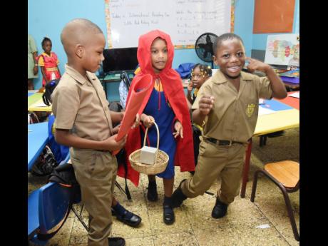 A student dressed as  Little Red Riding Hood interacts with classmates at Stony Hill Primary and Infant School in St Andrew while celebrating International Literacy Day at their school yesterday.