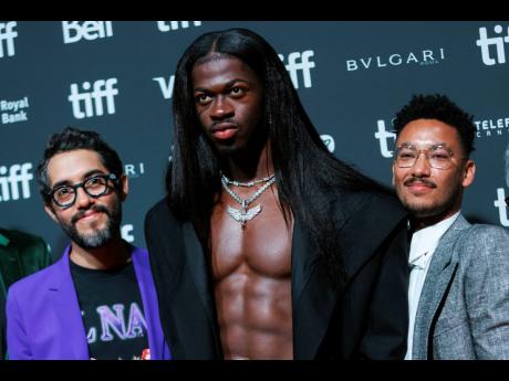 Directors Carlos Lopez Estrada, left, and Zac Manuel, right stand with Lil Nas X as they arrive on the red carpet ahead of the premiere of ‘Lil Nas X: Long Live Montero’ at the Toronto International Film Festival last Saturday.