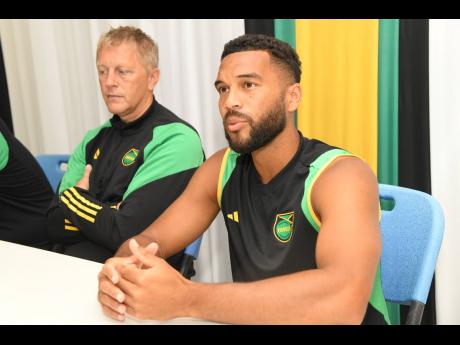 Jamaica’s Adrian Mariappa (right) speaks to media during a pre-game press conference ahead of a Concacaf Nations League A Game against Haiti on Monday. Looking on is national coach Heimir Hallgrimsson.