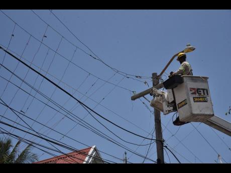 
In this August 2022 photo, a JPS contractor is seen repairing powerlines. Ansord Hewitt writes: The OUR has also worked with the JPS to improve service and secure significant benefits for consumers. 