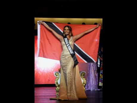 Christin Coeppicus holds the Trinidad and Tobago flag high after winning the 2023 Miss Global International title.