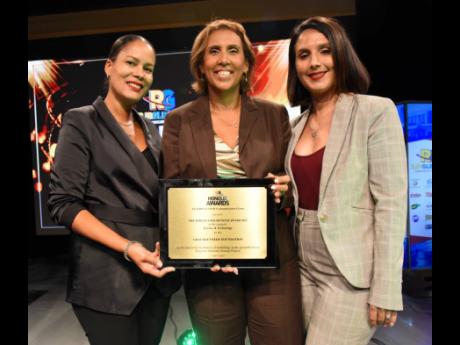 From left: Gail Moss-Solomon, general counsel, GraceKennedy; Caroline Mahfood, CEO of the GraceKennedy Foundation; and Suzanne Nam (right), head of corporate communications at GraceKennedy, share the frame as they pose with their award.