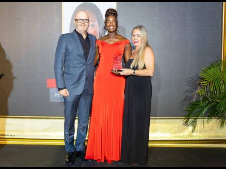 Nastasia Shields (centre), senior revenue assurance manager for Digicel Business, is joined by Darragh Fitzgerald-Selby (left), general manager for Digicel Business, as she accepts her award for outstanding leadership from Pauline Murphy, group CFO for Dig