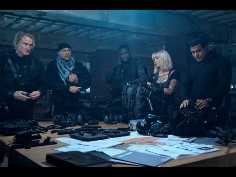 From left: Dolph Lundgren, Randy Couture, Curtis Jackson, Levy Tran and Jacob Scipio in a scene from ‘The Expend4bles’. 