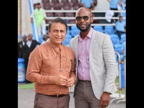 Cricket West Indies President, Dr Kishore Shallow (right), with Indian cricket legend Sunil Gavaskar during the recent 100th Test match between West Indies and India at the Queen’s Park Oval in Trinidad and Tobago. 