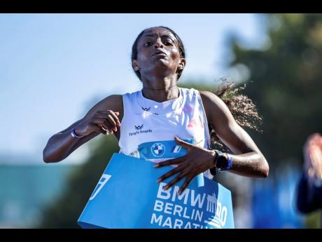 Ethiopia’s Tigst Assefa crosses the finish line in world-record time at the Berlin Marathon on Sunday, September 24, 2023. 