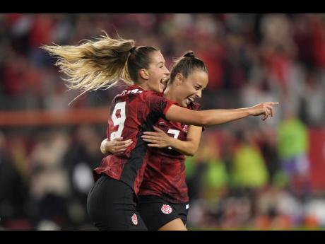 Canada’s Jordyn Huitema (left) celebrates her goal with teammate Julia Grosso during the second half of a Concacaf Olympic qualification tie against Jamaica in Toronto yesterday.