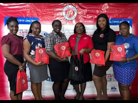 Prime Trust Financial Corporation Ltd (Half-Way Tree branch) displayed its commitment to education when it donated 50 back-to-school packages to its staff. Posing with their packages (from right) are Fraincene Kelly-Thorpe, Tishema Nelson, Sancia Allen, Jo