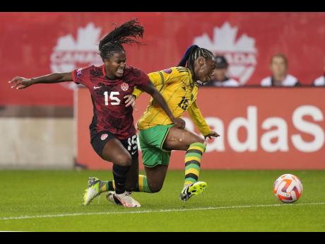 Canada’s Nichelle Prince (left) battles with Jamaica’s Tiffany Cameron for the ball during the first half of their second leg Concacaf Olympic qualifier in Toronto on Tuesday night. Canada won 2-1 for a 4-1 aggregate win.