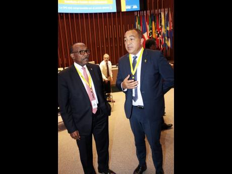 Minister of Health and Wellness Dr Chris Tufton and Antigua and Barbuda’s Minister of Health, Wellness and Social Transformation, Molwyn Joseph, in deep conversation at the opening of the 60th Directing Council of the Pan American Health Organization, at