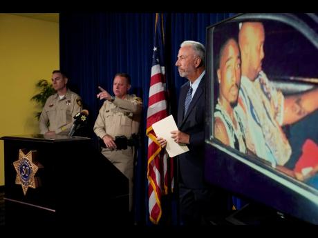 From left: Las Vegas Police Lieutenant Jason Johansson, Sheriff Kevin McMahill and Clark County District Attorney Steve Wolfson attend a news conference on Friday, in Las Vegas, on an indictment in the 1996 murder of rapper Tupac Shakur.
