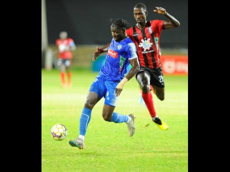 Trivante Stewart (left) in action for Mount Pleasant  during a  Jamaica Premier League match against Arnett Gardens at Sabina Park in May. At right is Joel Cunningham of Arnett Gardens.