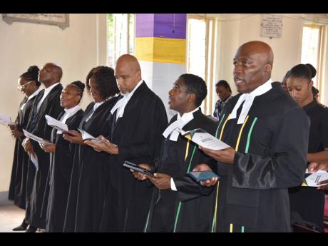 Chief Justice Bryan Sykes (right) at the Annual Assize Church Service worshipping with members of the judiciary at the William Knibb Memorial Baptist Church.