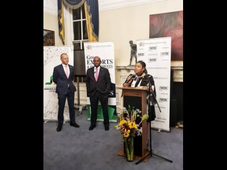 Acting Jamaica High Commissioner Patrice Laird-Grant introduces Senator Aubyn Hill at a reception at the Jamaica High Commission in London. Looking on at right is Laurence Jones, head of JAMPRO’s European Regional Office.