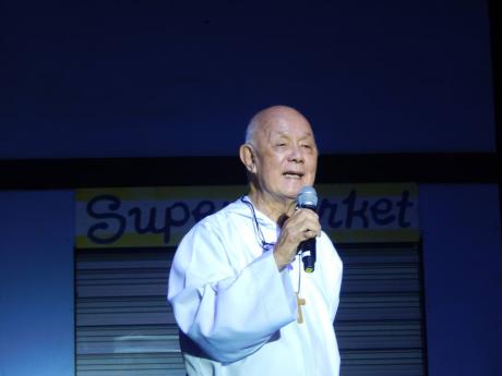 Father Richard Ho Lung speaks to the audience at the National Arena on Sunday about his musical ‘Ruby Magdelene’.