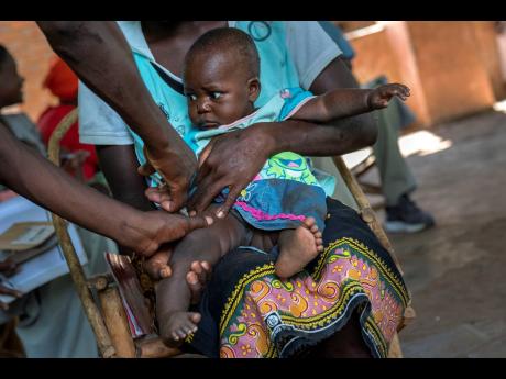 A baby from the Malawi village of Tomali is injected with the world’s first vaccine against malaria in a pilot programme on December 11, 2019. The World Health Organization authorised a second malaria vaccine on Monday, a decision that could offer countr