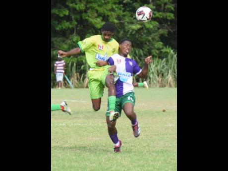 William Knibb’s Amari-Christopher Reid (right) tussles with Ocho Rios’ Joaquin Corothers during an ISSA/WATA daCosta Cup game at the William Knibb Sports Complex on September 20.