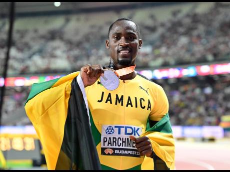Jamaica’s Hansle Parchment shows off the silver medal he won at the World Athletics Championships in Eugene, Oregon, on August 21.