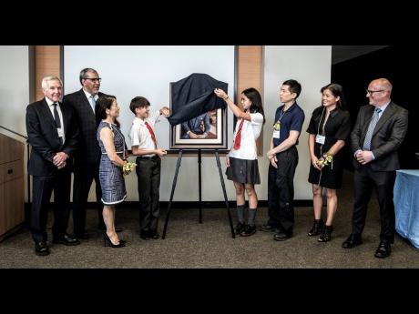 The family of G. Raymond Chang unveils a portrait of him at The Chang School. Left to right: Jack Cockwell, honorary board member of TMU; Mohamed Lachemi, president and vice-chancellor of TMU; Donette Chin-Loy Chang, Lucas Addorisio, Savanna Addorisio, And