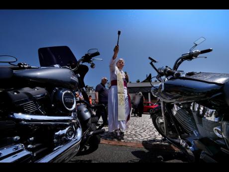 Bishop Emeritus of Sanggau, West Borneo, Giulio Mencuccini, 77, blesses the participants of a pilgrimage of bikers to the St Gabriele dell’ Addolorata sanctuary in Isola del Gran Sasso near Teramo in central Italy on June 18, after celebrating Mass for t