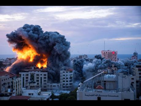 Fire and smoke following an Israeli airstrike from Hamas in Gaza City yesterday.