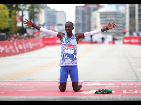 Kenya’s Kelvin Kiptum celebrates his Chicago Marathon world record victory in Chicago’s Grant Park yesterday.