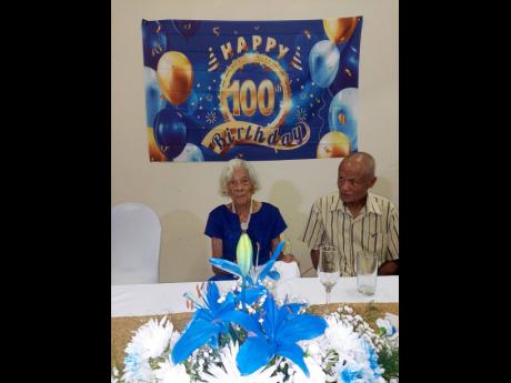 Sybil Robinson seated with son, Donald Robinson, at her 100th birthday party.