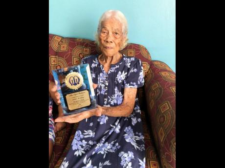 Centenarian Sybil Robinson showing one of her many Mother’s Union awards. 