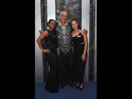Glenn Lawrence (centre), director, Couples Resorts, is sandwiched between Jheanell Adjudah (left), Trelawny Cooperative Credit Union, and Simone Lawrence. 