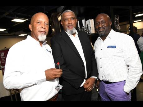 Oscar Kerr (left), head of sales, BlueStart Capital; Philip Roach (centre), corporate merchandise buyer, Unicomer Group Jamaica Limited; and Aswad Morgan, director, Therapedic Caribbean, pause their lively discussion for a quick snap. 