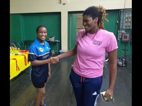 Women’s singles winner Tsenaye Lewis (left) greets runner-up Brittany Murray after the final. 