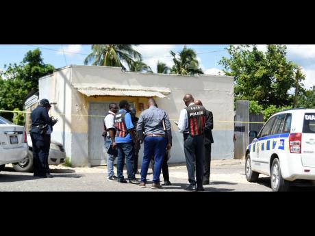 Police personnel from the Major Investigation Division arrived at the scene of a double murder in the community Parks Road in Rural St Andrew.  