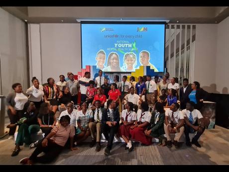 Students and members of youth-led organisations gather for a photo opportunity during the National Youth Mental Health Summit, hosted by the United Nations Children’s Fund, at the AC Hotel by Marriott Kingston recently.