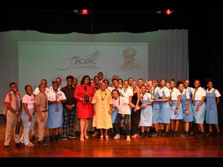 Members of Ardenne High School’s performing arts team show off their trophies while striking a pose with the Olivia Grange (front row, centre), minister of culture, gender, entertainment and sport. The school was declared winners of the JCDC Marcus Garve