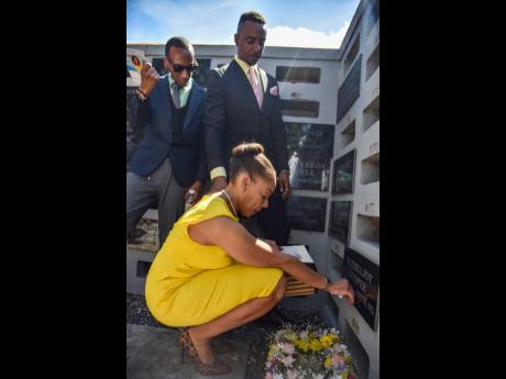From left: Sons Akiri Cooper and Abean Cooper and daughter Arianne Cooper say their last goodbyes to their mother, the late Althea ‘Joy’ Cooper.