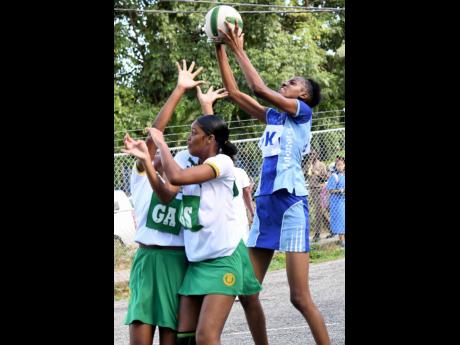 St Catherine High’s goal keeper Kaydene  Gordon (right) grabs a rebound during yesterday’s ISSA urban schoolgirls under-19 netball  match against St Jago High at  St Catherine High in Spanish Town. St Catherine won 41-32.  