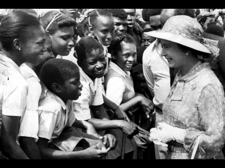In this file photo Queen Elizabeth is greeting school children at the National Heroes Park. 