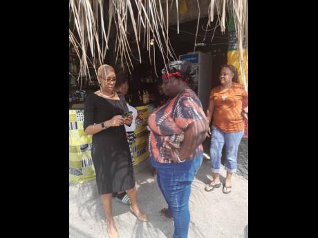 Member of Parliament Fayval Williams speaks to concerned operators about the planned reclaim of the property located at 35 Gordon Town Road in St Andrew. Yesterday’s demolition was suspended. In the background is PNP representative for Eastern St Andrew,