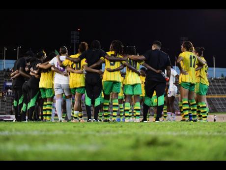 Jamaica’s Reggae Girlz huddle after a 2-0 defeat to Canada inside the National Stadium in an Olympic qualification tie, which would have given them an automatic Women’s Gold Cup berth.
