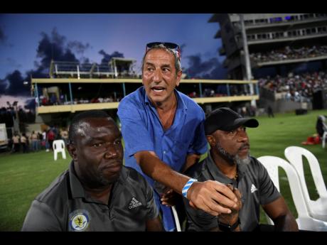 Mount Pleasant’s owner Peter Gould (centre) watches last year’s Jamaica Premier League (JPL) final against Arnett Gardens at Sabina Park with coach Theodore Whitmore (left) and goalkeeper coach Warren Barrett. Mount Pleasant would beat Arnett and go on