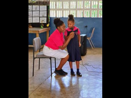 Christene Neil-Wright interacts with a budding young poet.