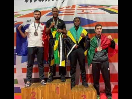 Jamaica’s Nicholas Dusard (second left) is flanked by silver-medallist Thomas Falmad (left) of France, bronze medallists Nicholai Reid (third left) and Portugal’s Goncala Ferreira after winning light-heavyweight continuous-sparring gold at the October 