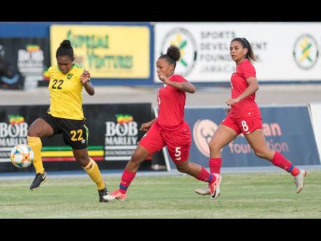 Reggae Girl Mireya Grey (left) dribbles to goal ahead of  Yomira Pinzon (centre) and Laurie Batista of Panama during a friendly match at the National Stadium in May 2019. Jamaica won 3-1.