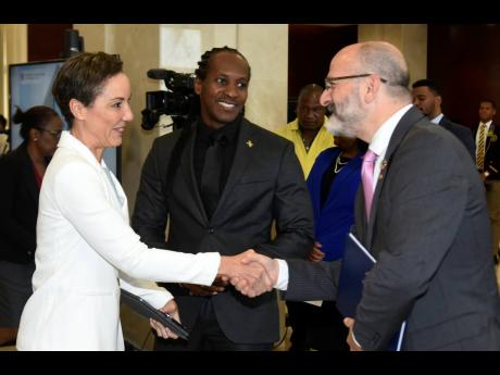 From left: Foreign Affairs Minister Kamina Johnson Smith and Foreign Affairs State Minister Alanda Terrelonge greet Ian Stein, resident coordinator ad interim at the Office of the United Nations (UN) during a session to mark UN Day at the Ministry of Forei