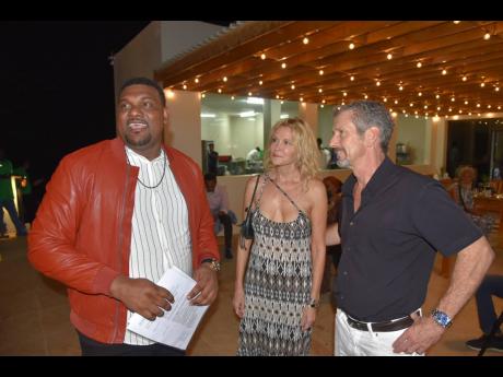Garth Vickers (left) is captured socialising with two of his friends from the West Cliff Community in Negril, Westmoreland, at the soft opening of his High Life Restaurant.