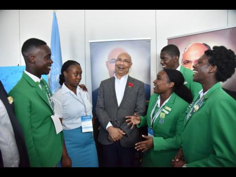 Governor General Sir Patrick Allen (centre) speaks with students attending yesterday’s Youth Consultative Conference, under the theme ‘I Believe’, at the AC Marriott Hotel in St Andrew.
