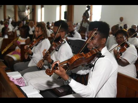 Musicians play tributes to Ibo Cooper at his thanksgiving service.