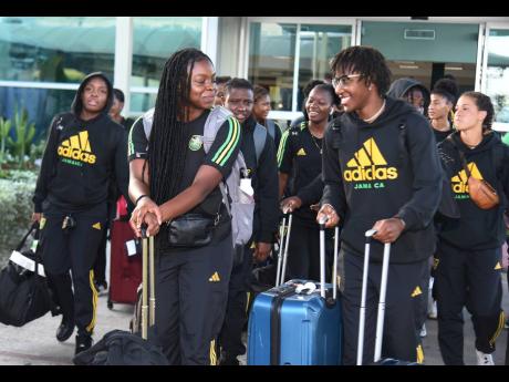 Members of the new-look Reggae Girlz squad at the Norman Manley International Airport yesterday shortly after arriving from Panama. 